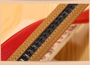 Detail shot of a premium brown leather belt featuring fine stitching and a notched inner track