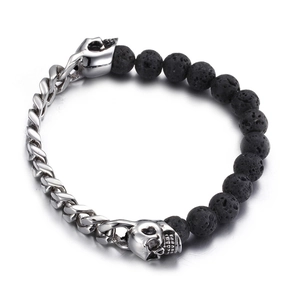 Punk style Cuban chain bracelet with black lava beads and skull charms on white background