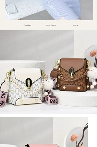 Detail of PU leather handbag with M-pattern monogram and metal O-ring buckle closure