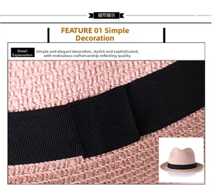 Gros plan d'un chapeau fedora en paille rose avec ruban noir et texture de tissage fin