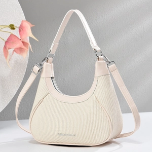 Detailed view of cream Hobo bag with vertical pleats and metallic CHDESGN logo accent
