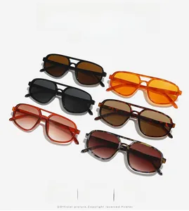 Flat lay of vintage double-bridge sunglasses in black, orange, and tortoiseshell colors