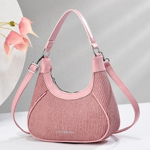 Detail of pink pleated hobo bag with smooth leather trim and silver metal hardware