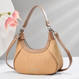 Elegant woven shoulder bag with brown leather accents and CB DESIGN logo on display