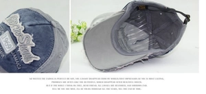 Detail of Rock Shark embroidery and adjustable metal buckle on vintage washed baseball cap