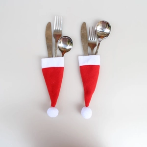 Set of two red and white Santa hat silverware holders with stainless steel cutlery set