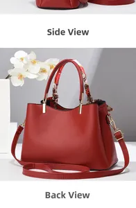 Detail view of red leather tote bag with elegant floral scarf handle and gold hardware