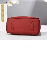 Detailed close-up of the red textured leather bag bottom with reinforced stitching