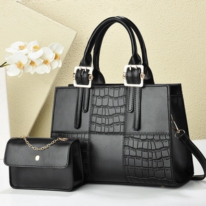 Black crocodile-embossed leather tote bag set with gold hardware and small chain pouch