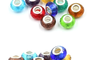 Close-up of faceted crystal glass beads with silver metal cores in various vibrant colors