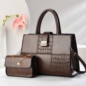 Dark brown leather tote bag with stone pattern stitching and a small chain pouch
