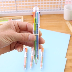 Macro shot of 6-color transparent ballpoint pen being held for multi-color writing