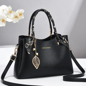 Elegant black lychee leather handbag with silk scarf handle and gold leaf pendant