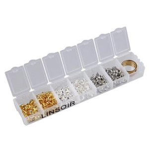 Detailed view of a 7-compartment plastic organizer box with gold and silver jump rings