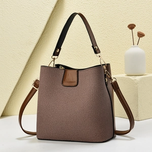 Fashion bucket bag in coffee leather and beige fabric with adjustable shoulder strap