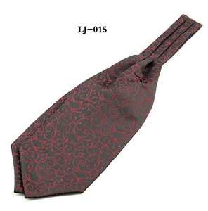 Detail of dark grey cravat scarf featuring red floral jacquard and vine pattern textures