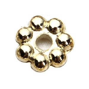 Macro shot of gold floral metal spacers for DIY jewelry making and bracelet crafting