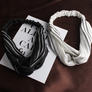 Detail of black and white twist headbands with textured stripes and elastic back band