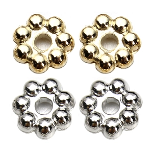 Macro detail of snowflake CCB spacer beads in gold and silver finish for DIY jewelry