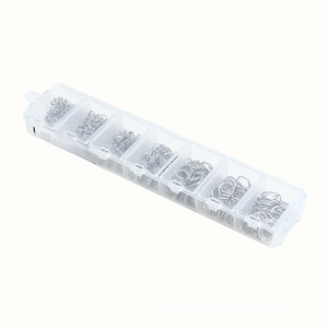 Detailed macro view of 7-compartment storage box with assorted silver DIY jump rings