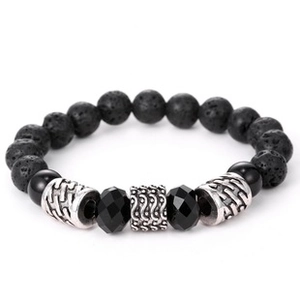 Macro detail of black volcanic stone bracelet with silver metal beads on white background