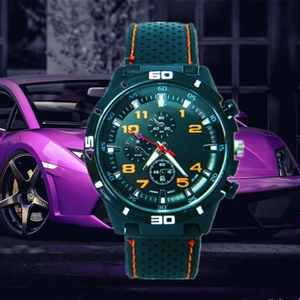 Men's sports chronograph watch with orange accents and a black rubber strap in front of a car