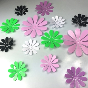 Flat lay of colorful 3D daisy wall decorations in various sizes and vibrant finishes