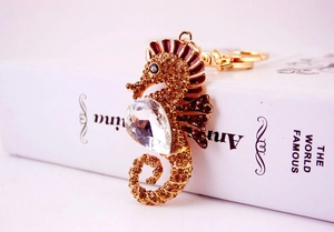 Close-up of golden seahorse keychain with sparkling rhinestones and brown enamel details
