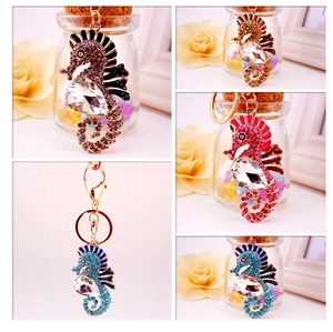 Detail view of rhinestone seahorse keychains in brown, gold, red, and blue crystal colors