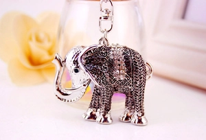 Detail of silver vintage elephant keychain with sparkling rhinestones and floral engraving