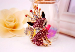 Detailed close-up of a golden fox keychain with pink and white rhinestone embellishments