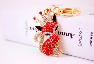 Macro shot showing sparkling red and clear rhinestones on a gold fox keychain pendant