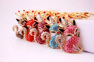 Close-up of cute cartoon fox keychains with colorful rhinestones and gold plating