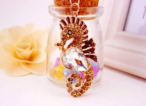 Detail of seahorse keychain with brown rhinestones and large faceted crystal centerpiece