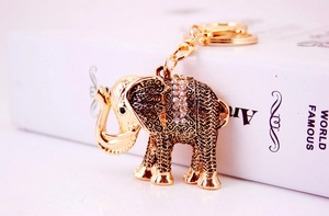 Detailed close-up of a golden elephant keychain with sparkling rhinestones and metal texture