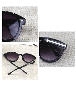 Detailed views of round kids sunglasses with silver metal arrows and purple gradient lenses