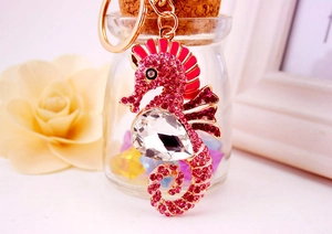 Close-up of pink rhinestone seahorse keychain with gold metal plating and clear crystal