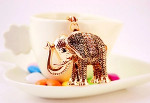 Detailed view of vintage gold elephant keychain with intricate hollow patterns and rhinestones