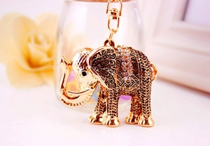 Close-up of golden metal elephant keychain featuring intricate texture and sparkling rhinestones