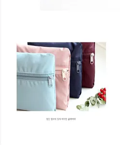 Close-up of matching color zipper sliders on waterproof nylon travel organizer bags