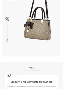 Détail de la poignée du sac cabas avec coutures précises et pendentif noeud élégant