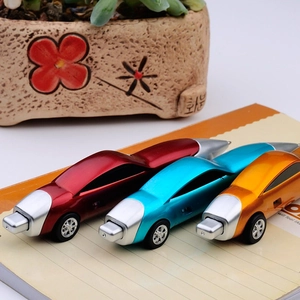 Three racing car shaped creative ballpoint pens in red blue orange on a notebook