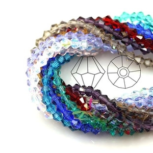 Macro view of multi-faceted bicone crystal fish pendants for DIY jewelry making