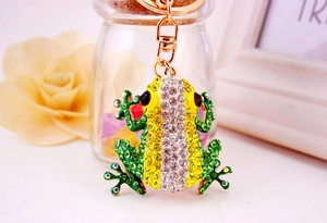 Close-up of golden frog keychain with green enamel and sparkling crystals on lobster clasp