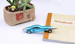 Detailed macro view of a creative blue sports car shaped ballpoint pen on a desk