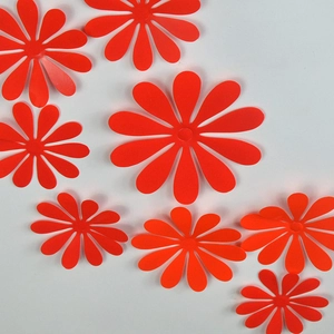 Detail view of red 3D flower wall stickers in various sizes with a glossy finish