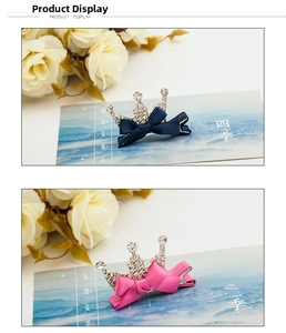 Detail of crystal crown hair clips with navy and pink bows and sparkling rhinestones