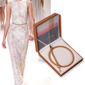 Minimalist gold metal chain belt for dresses shown on model and in a gift box
