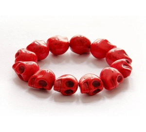 Detailed close-up of red skull beads made of synthetic stone for punk style bracelet