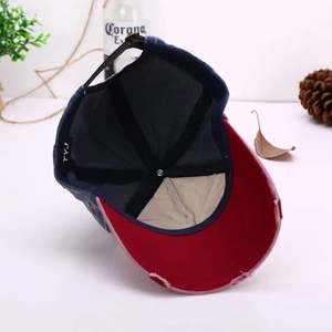Detail view of cotton baseball cap interior featuring TYJ label and worn edge visor